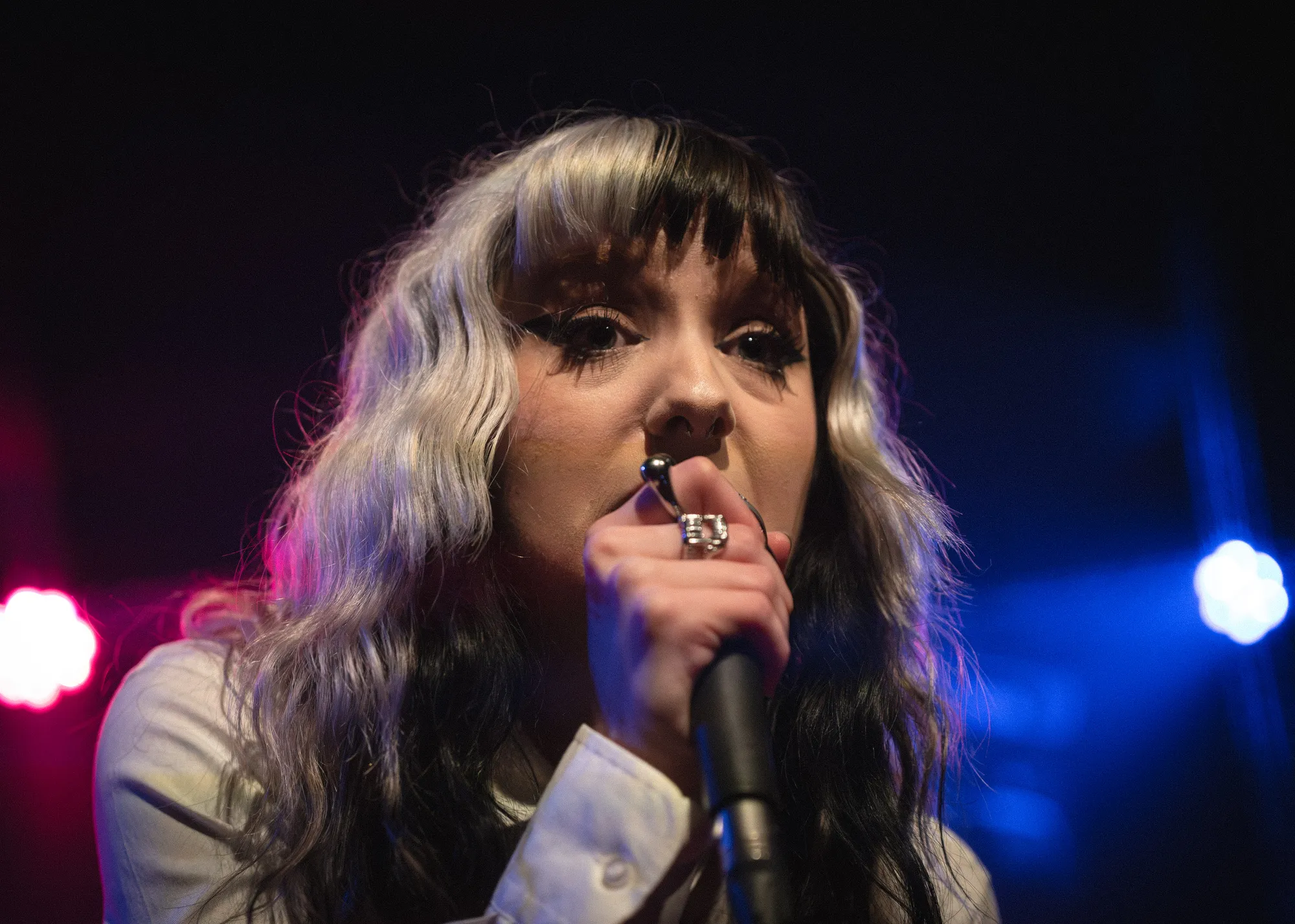 FKA Rayne close up in saturated orchid-toned light at the Wise Hall, 2026. Live photo by Spencer Nakamura.